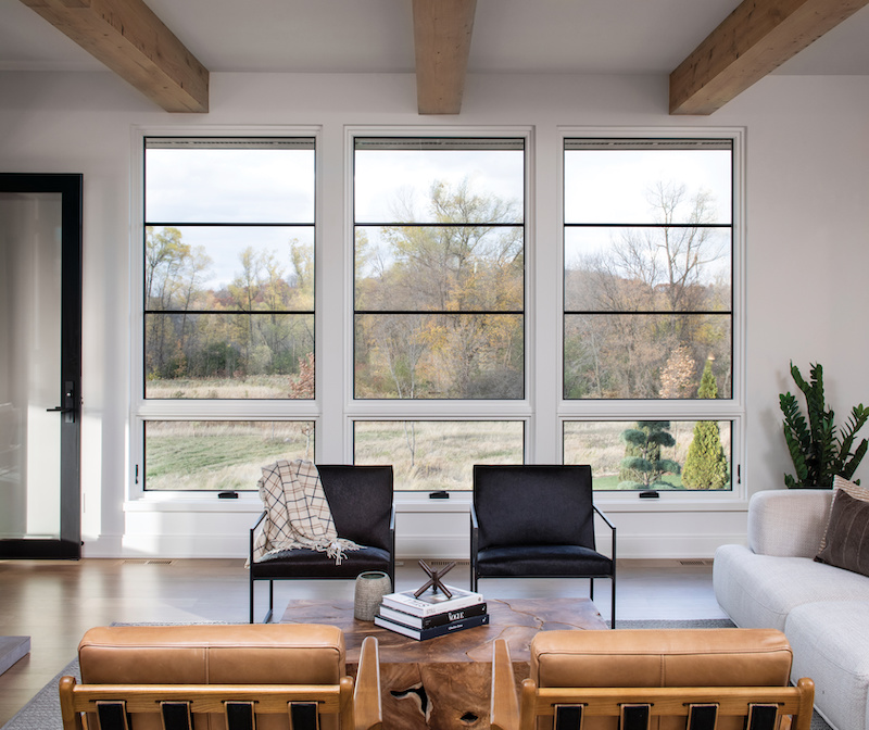 A modern, minimalist living room featuring Marvin Signature Ultimate casement windows.