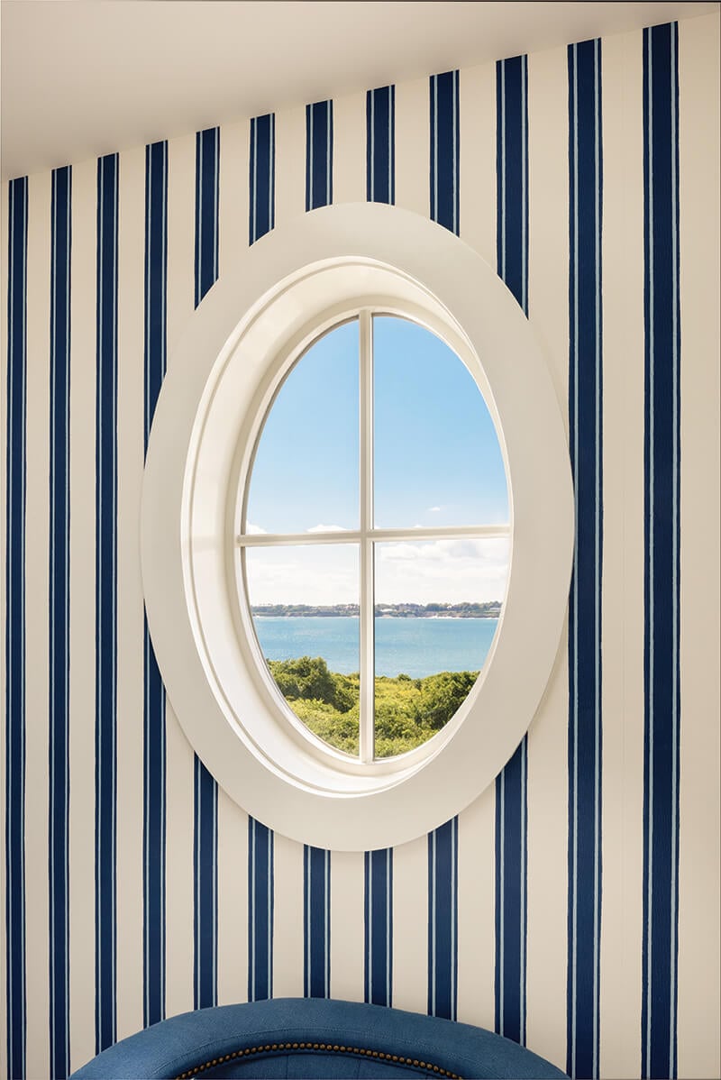A porthole-inspired oval window with a view of the Atlantic ocean.