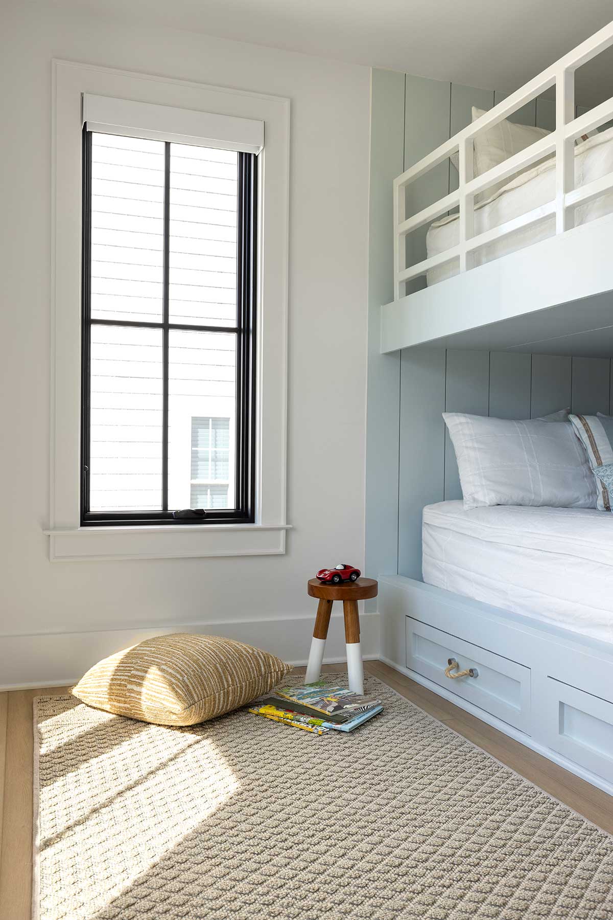 A kids' room with built-in bunk beds and a Marvin Elevate Casement window.