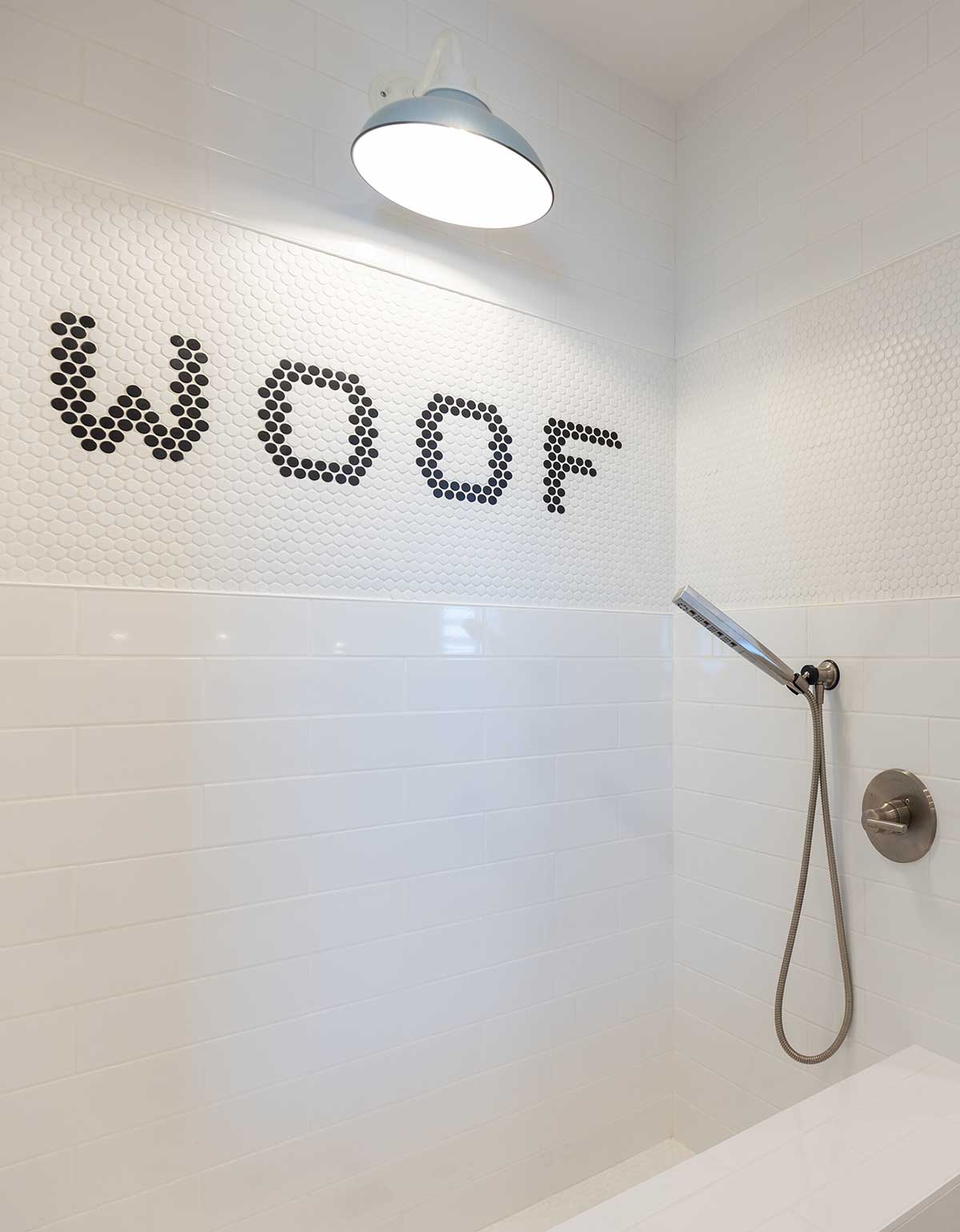 A dog bath with "woof" written in tile.