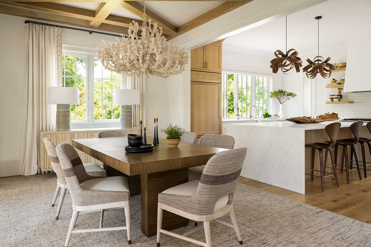 A dining room in a coastal home, featuring Marvin Ultimate Casement Push Out windows.
