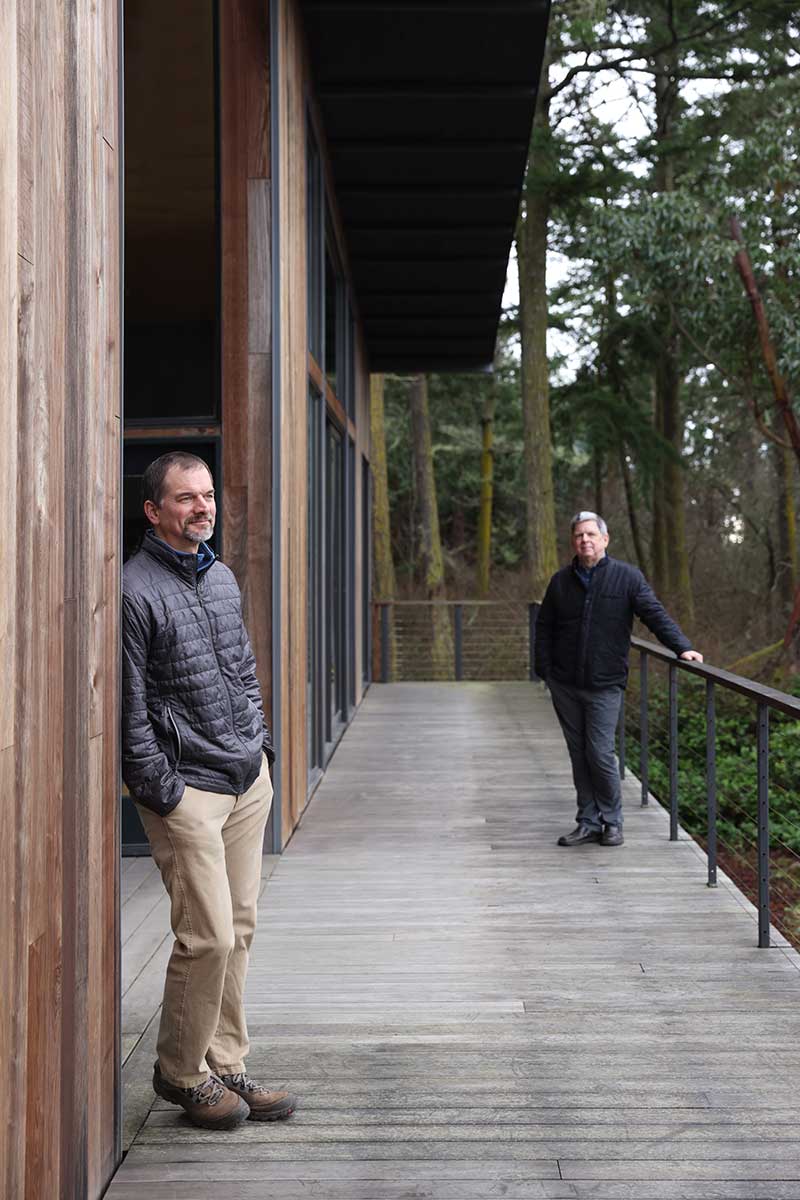 Peter Bates of Good Homes Construction and Dan Shipley of Shipley architects standing outside the Marrowstone Island residence they designed and built.