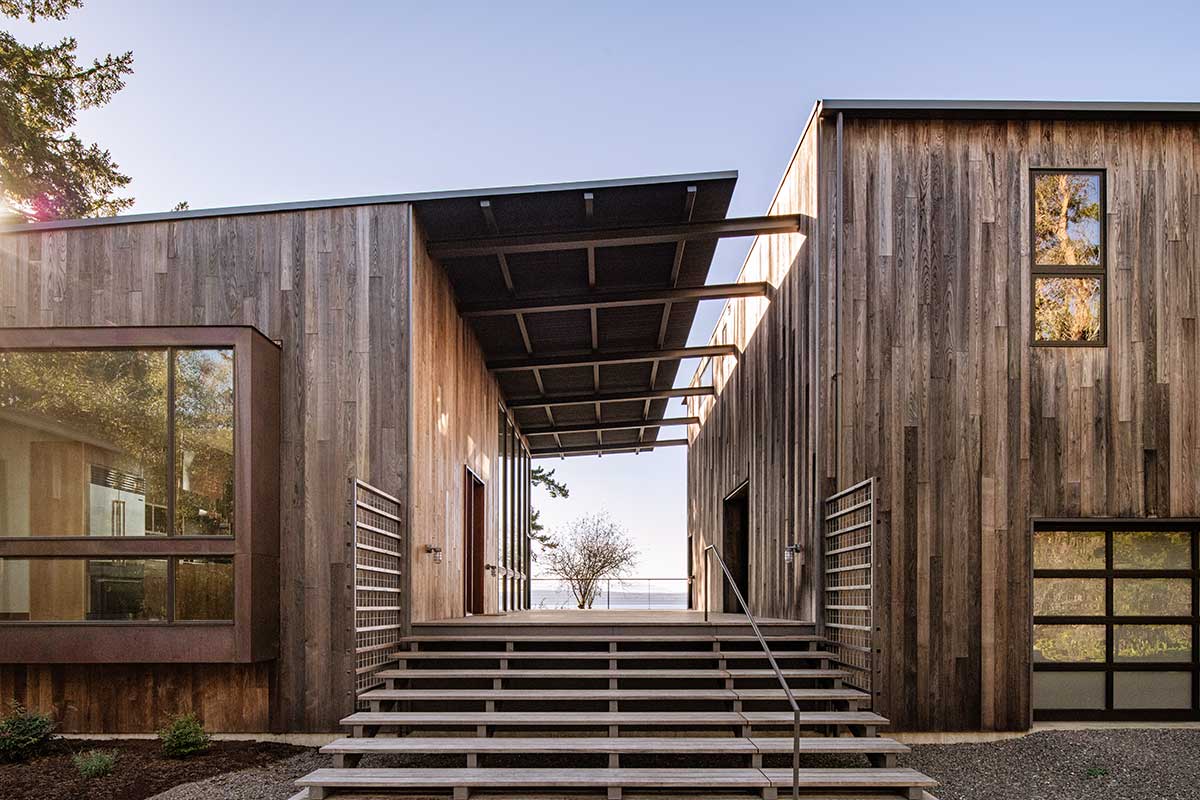 The exterior of a home overlooking Puget Sound with a dog trot between and Marvin Ultimate Direct Glaze and Casement windows.