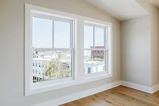 Marvin Ultimate Double Hung windows in a downtown home with views of rooftops and buildings. 