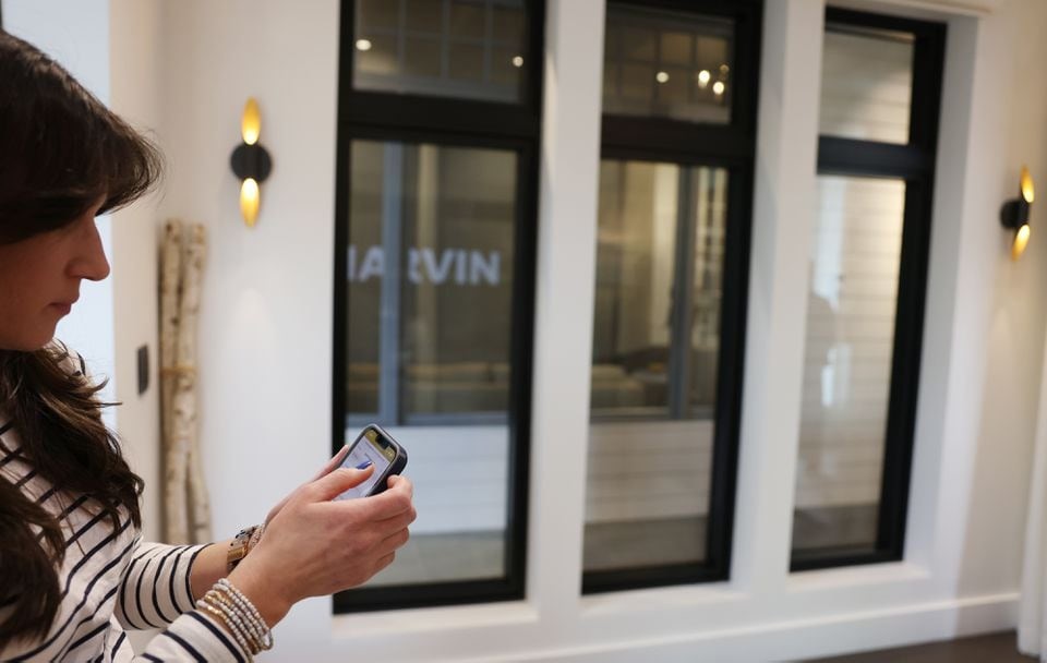 Lisa Massari, brand ambassador of Marvin at 7 Tide, used her phone to control the automated windows inside the showroom. JESSICA RINALDI/GLOBE STAFF