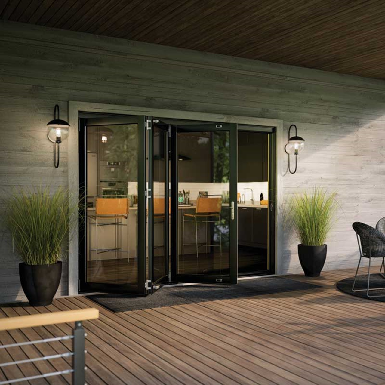 Exterior wood patio with table and chairs with black elevate bi fold door