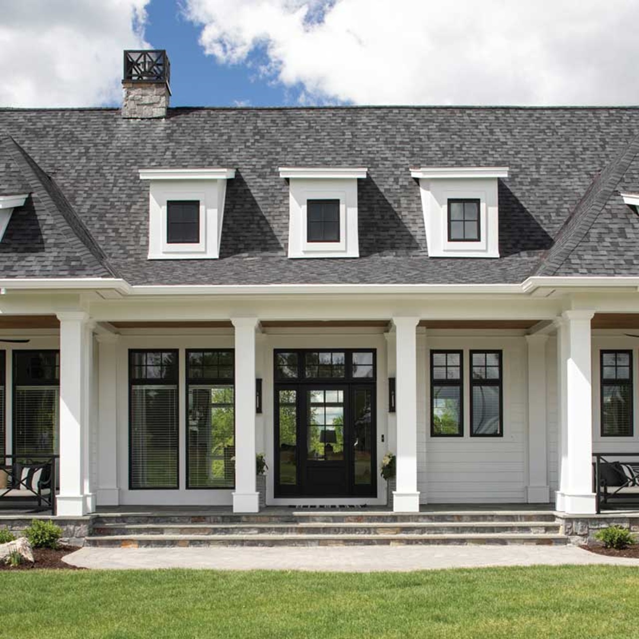 Front porch of white home with black marvin elevate windows