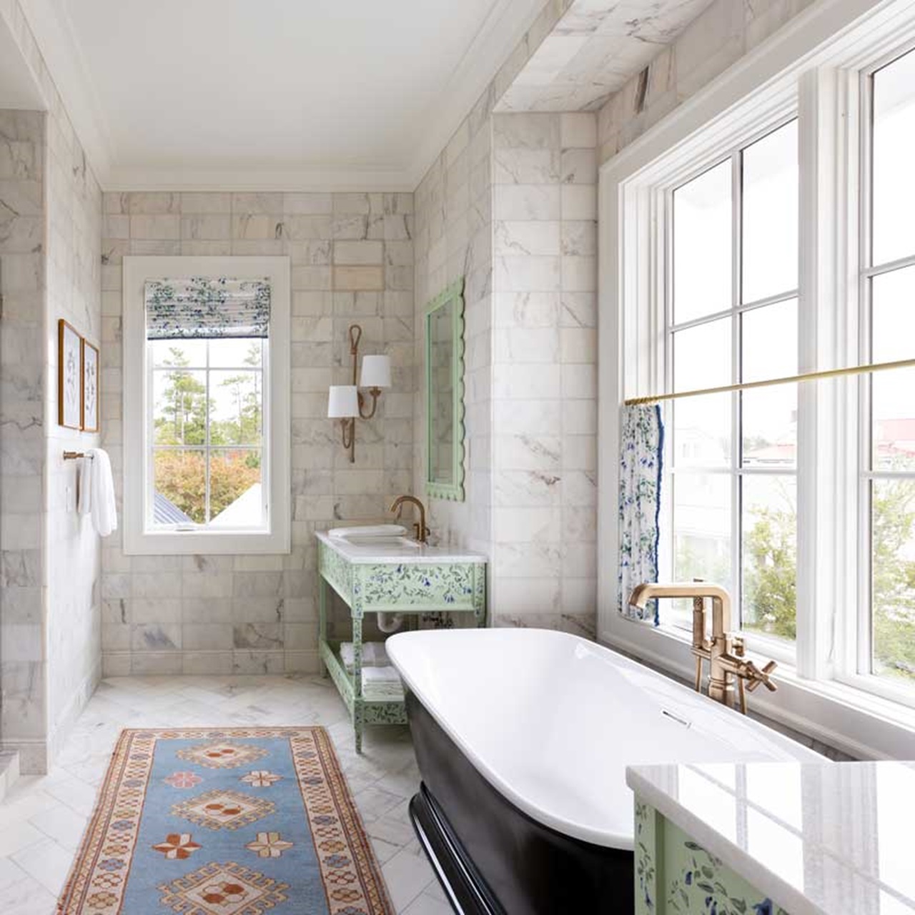 White marble bathroom with tub and elevate casement windows