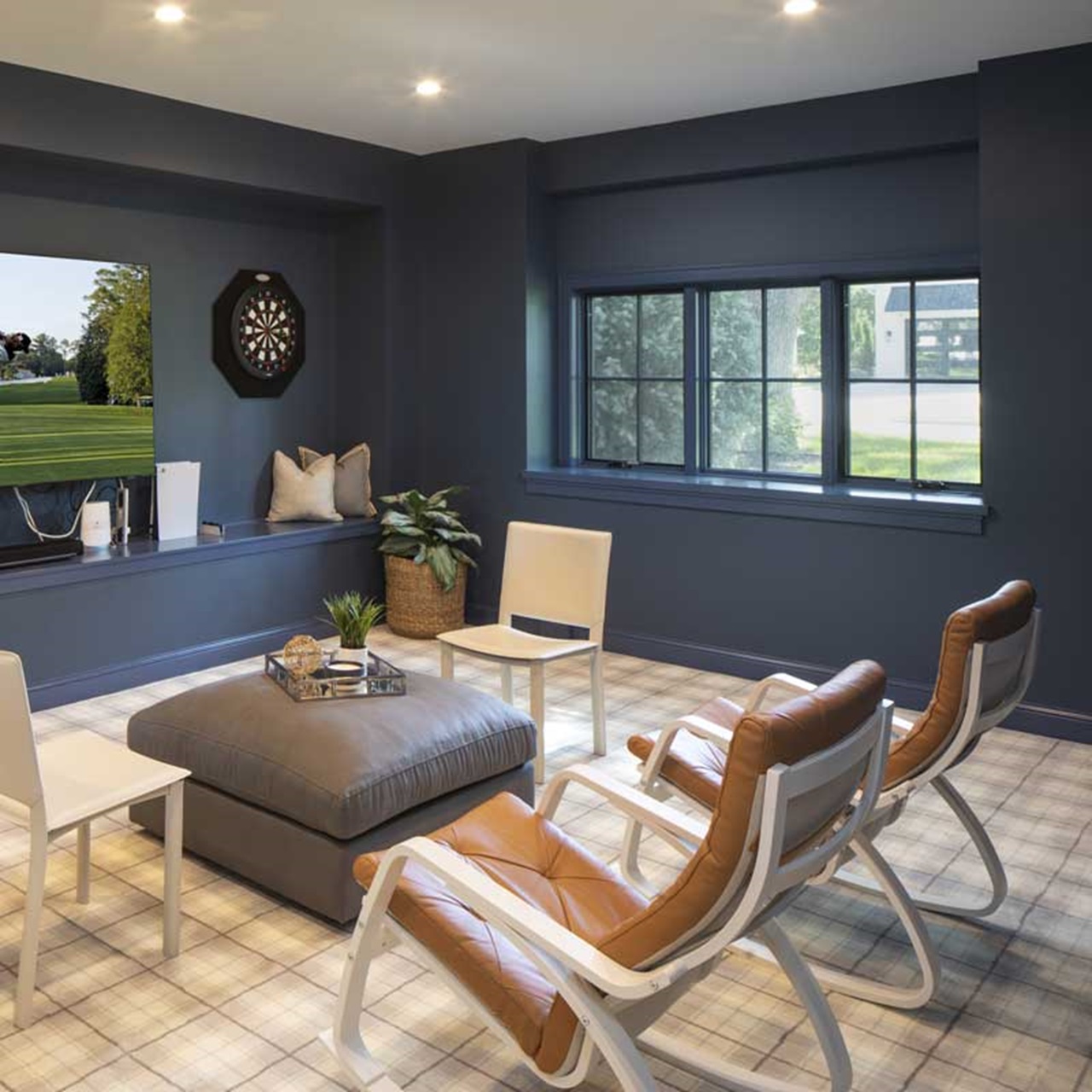 Dark grey entertainment room with tv and marvin elevate casement windows