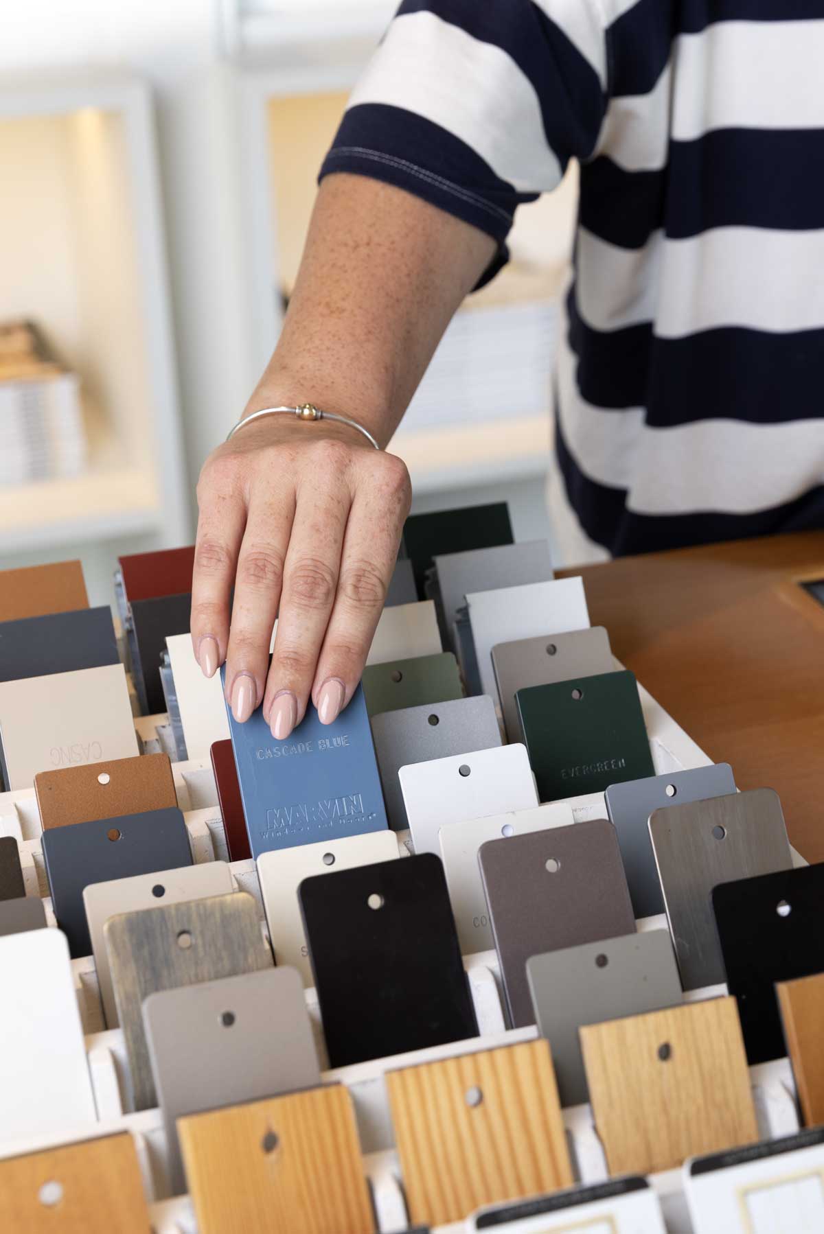 A person selecting swatches